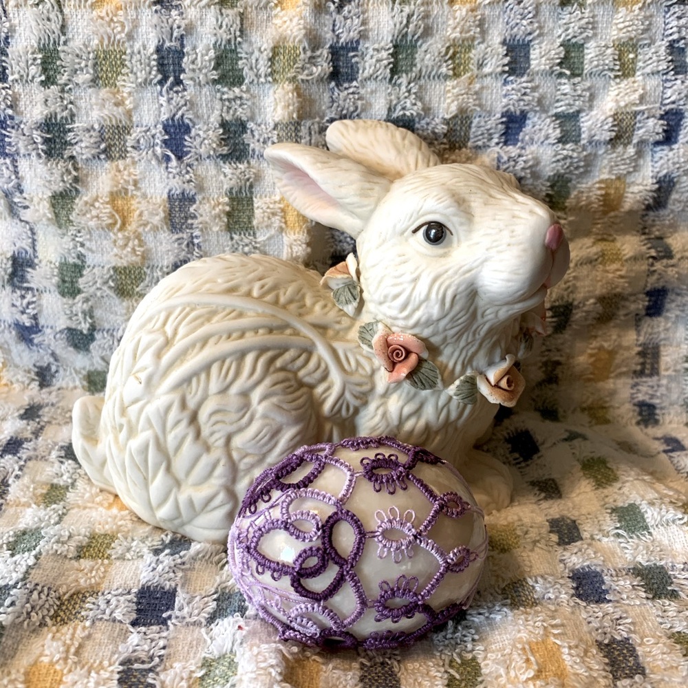 Polished stone egg with hand tatted decoration.  With egg cup for display